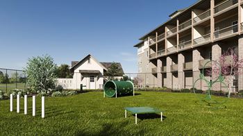 a yard with a green playground and an apartment building